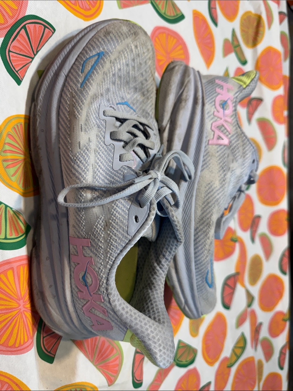 Hoka Light Gray Running Shoes with Pink Logo and Blue Accents